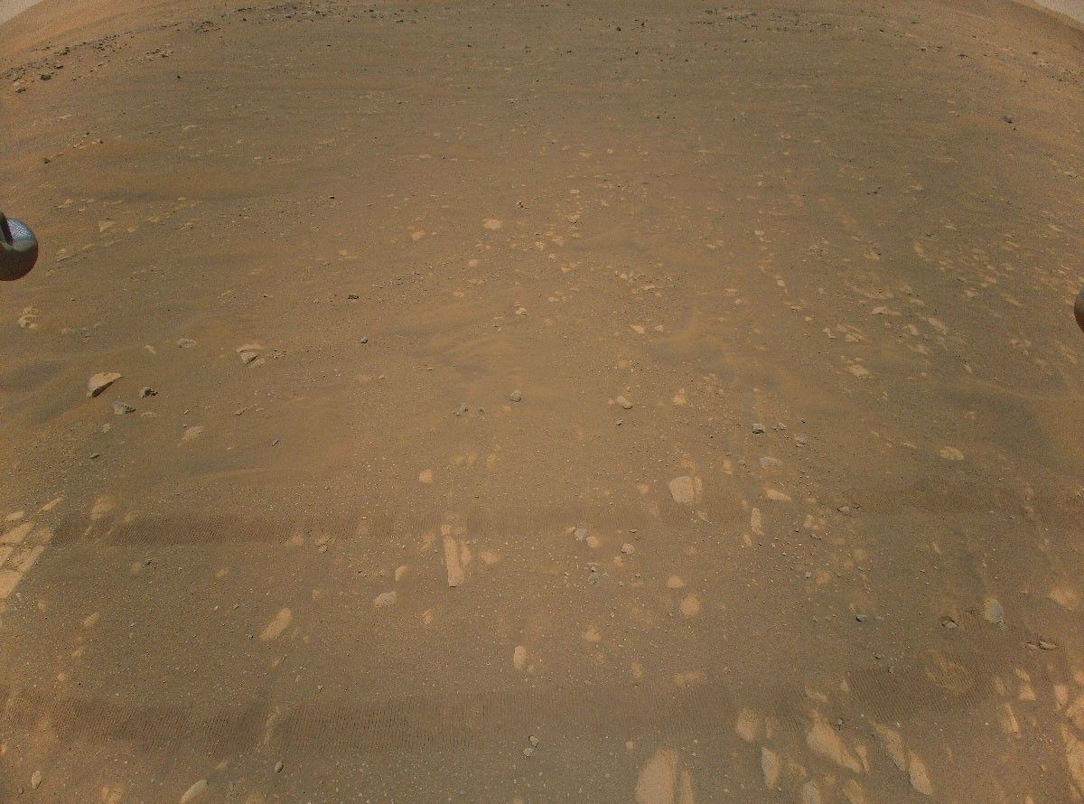This is the third color image taken by NASA’s Ingenuity helicopter. It was snapped on the helicopter’s second flight, April 22, 2021, from an altitude of about 17 feet (5.2 meters). Tracks made by NASA’s Perseverance Mars rover can be seen as well.
