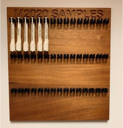 Six facsimile sample tubes hang on the sample tube board in this image taken in the offices of NASA’s Perseverance Mars rover.