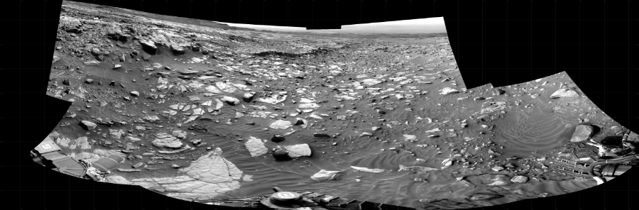 NASA's Mars rover Curiosity took 10 images in Gale Crater using its mast-mounted Right Navigation Camera (Navcam) to create this mosaic. The seam-corrected mosaic provides a 263-degree cylindrical projection panorama of the Martian surface centered at 303 degrees azimuth (measured clockwise from north). Curiosity took the images on March 14, 2022, Sol 3413 of the Mars Science Laboratory mission at drive 2928, site number 93. The local mean solar time for the image exposures was from 2 PM to 3 PM. Each Navcam image has a 45 degree field of view. CREDIT: NASA/JPL-Caltech