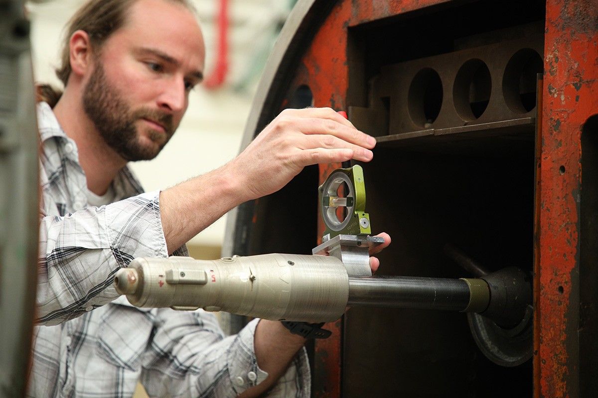 A scale model of the Mars Ascent Vehicle is loaded by Wind Tunnel Test Engineer Sam Schmitz into the trisonic wind tunnel at NASA’s Marshall Space Flight Center for testing.