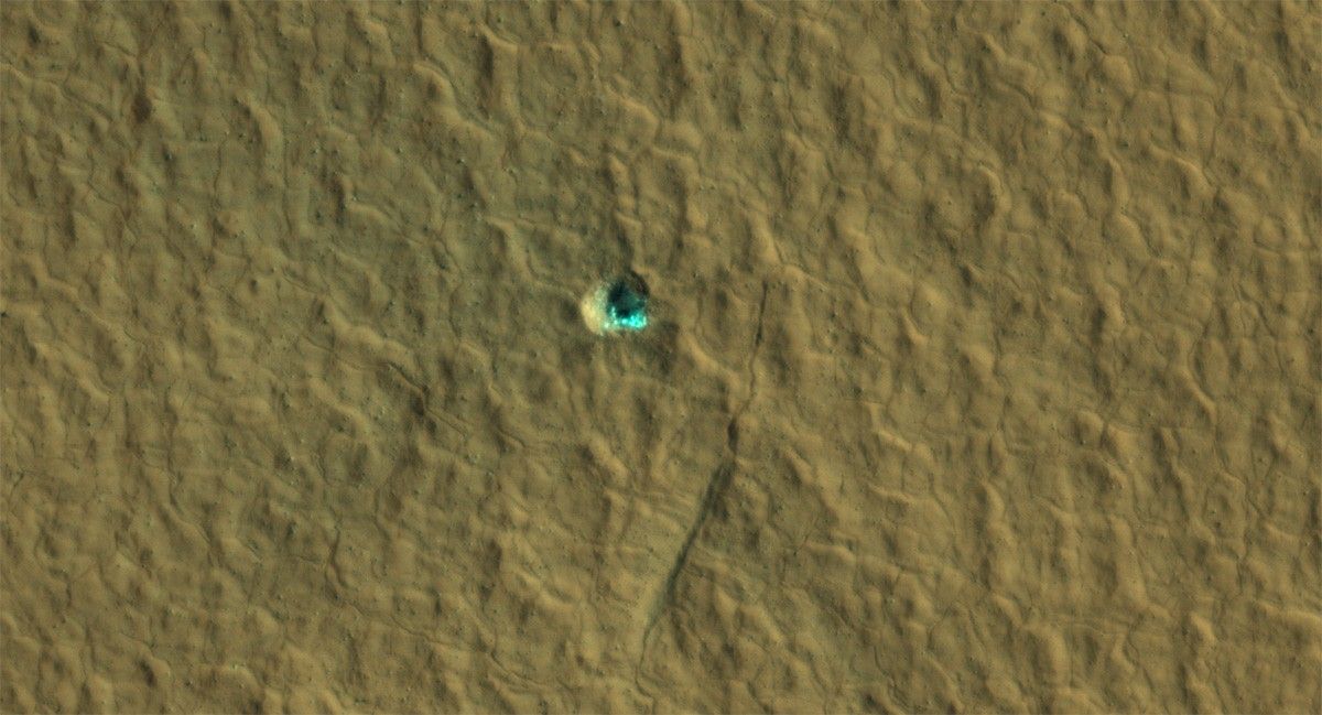 The ice-exposing impact crater at the center of this image is an example of what scientists look for when mapping places where future astronauts should land on Mars.