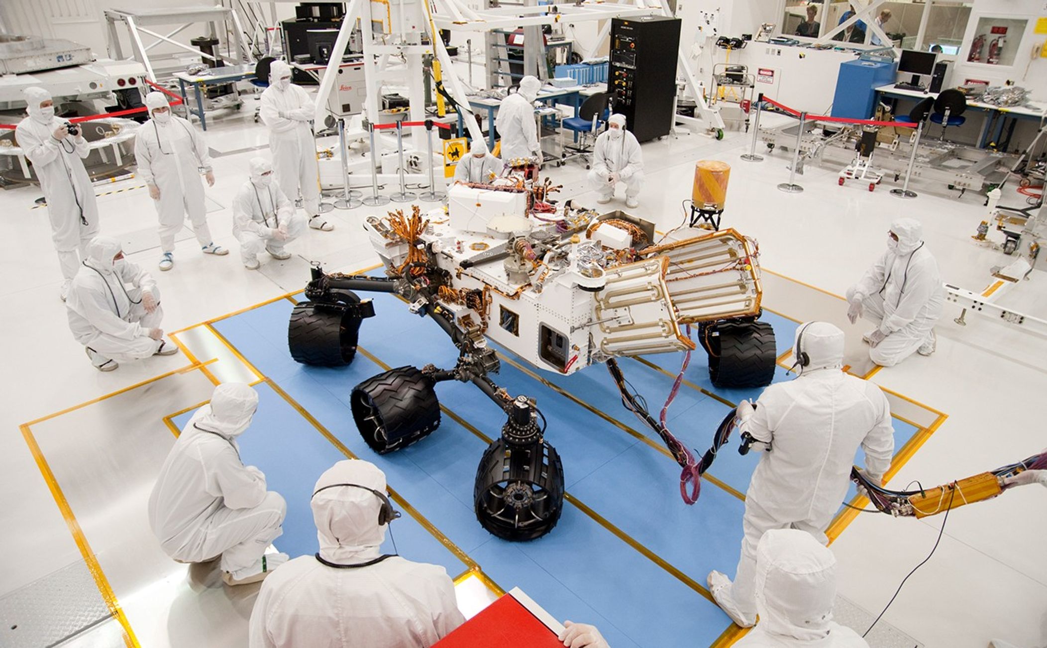 Technicians and engineers in clean-room garb monitor the first drive test of NASA's Curiosity rover, on July 23, 2010.