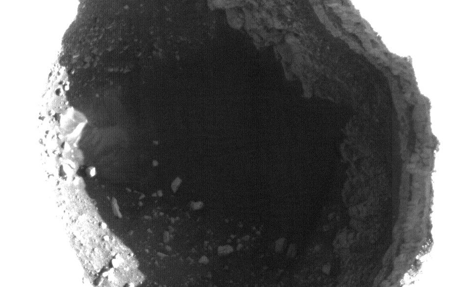 This enhanced image shows the inside of a rimless pit about 310 meters (1,017 feet) in diameter, northwest of the mountain Ascraeus Mons in the northern hemisphere of Mars.