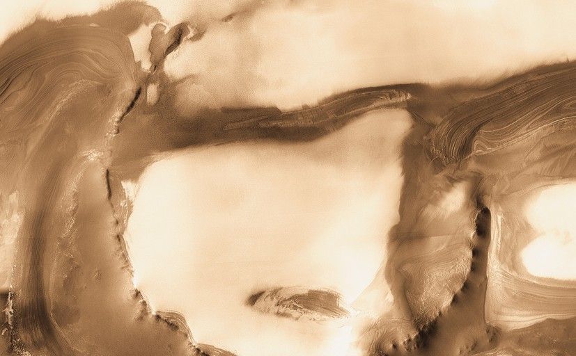 Although it is 45 kilometers (28 miles) wide, countless layers of ice and dust have all but buried Udzha Crater.
