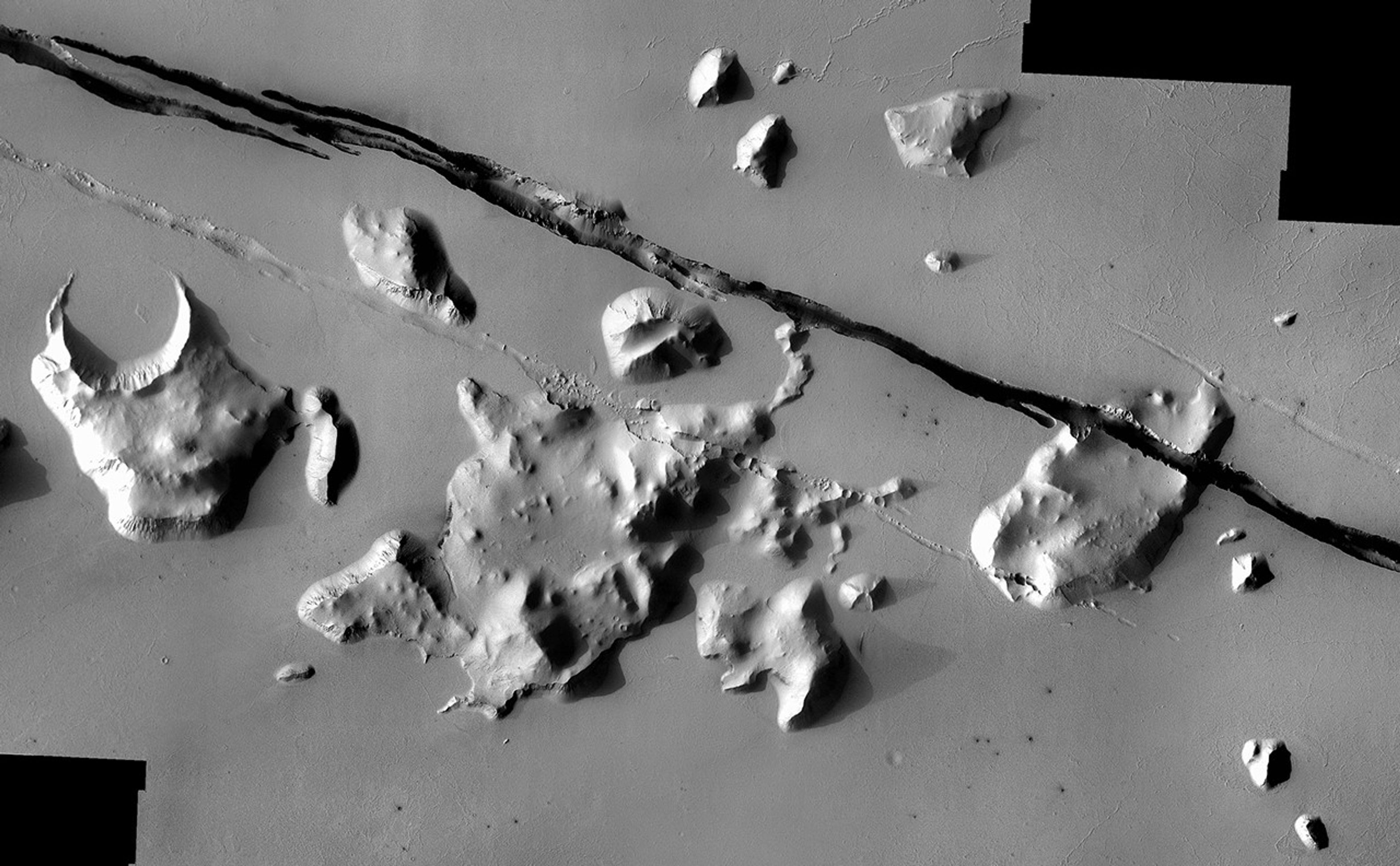 Geological faulting has opened cracks in the Cerberus region that slice through flat plains and mesas alike.