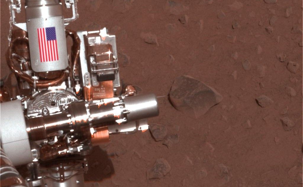The piece of metal with the American flag on it in this image of a NASA rover on Mars is made of aluminum recovered from the site of the World Trade Center towers in the weeks after their destruction.