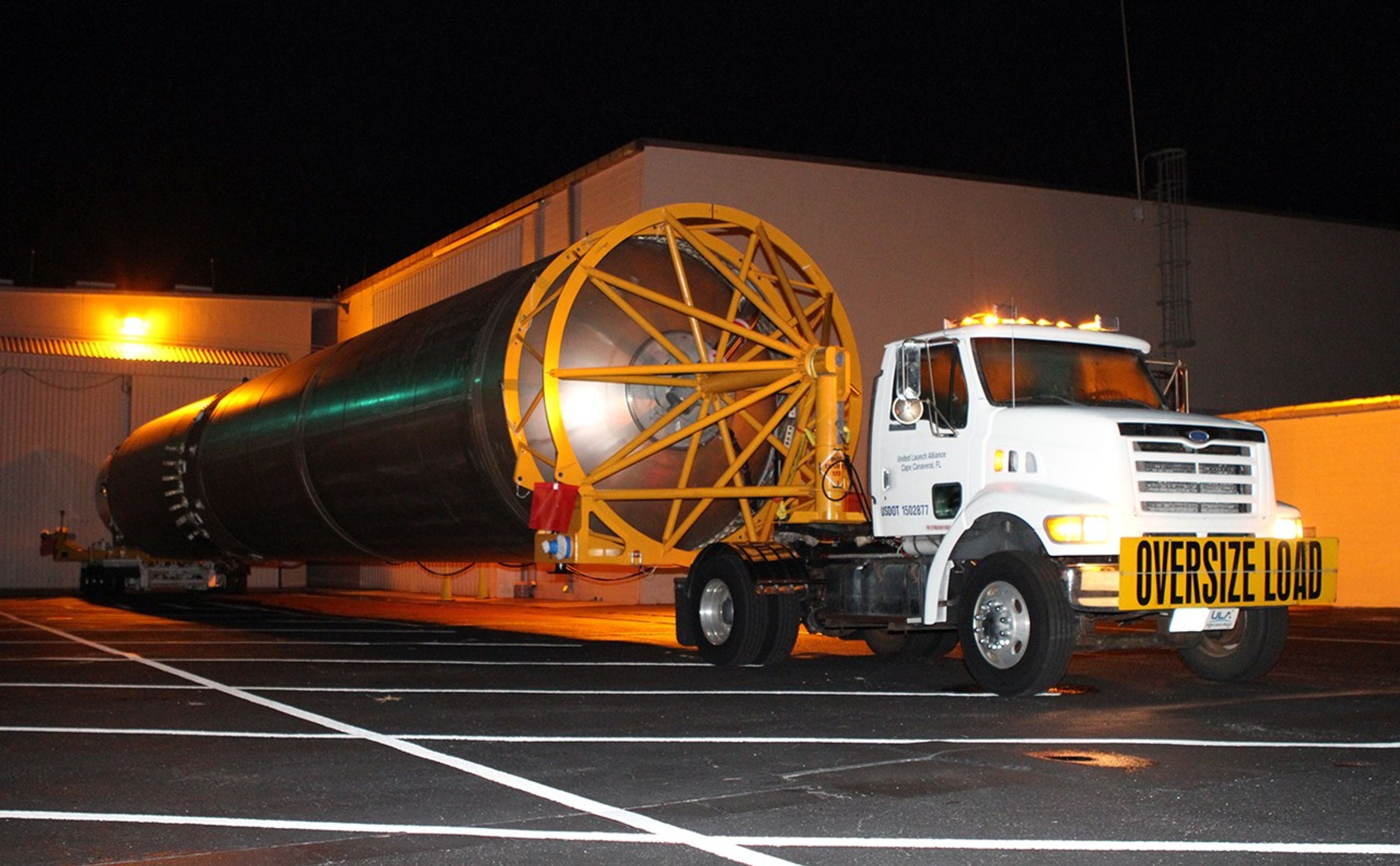 The first stage of the Atlas V rocket for NASA's Mars Science Laboratory (MSL) mission rolls out of the Atlas Spaceflight Operations Center on Cape Canaveral Air Force Station in Florida bound for the launch pad.