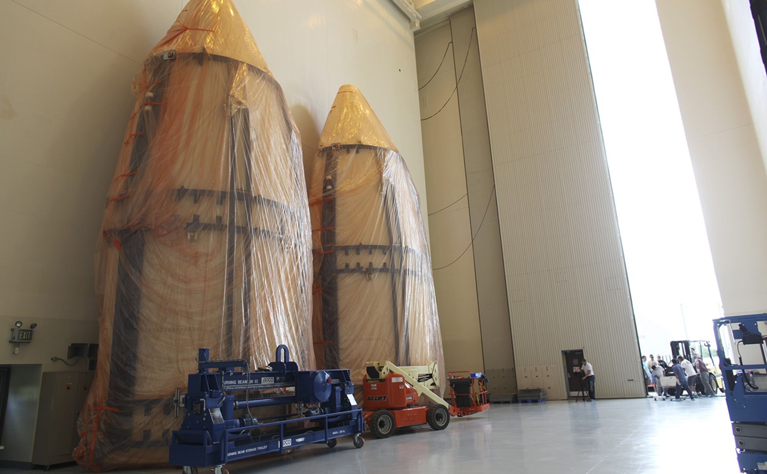 The dual sections of the Atlas V payload fairing for NASA's Mars Science Laboratory (MSL) mission await further processing in the airlock of the Payload Hazardous Servicing Facility at NASA's Kennedy Space Center in Florida.