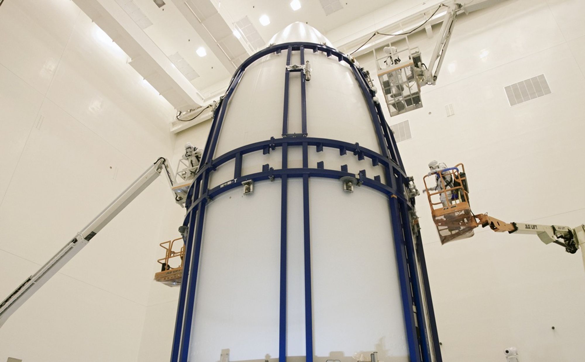 In the Payload Hazardous Servicing Facility at NASA's Kennedy Space Center in Florida, spacecraft technicians secure an Atlas V rocket payload fairing around NASA's Mars Science Laboratory (MSL).