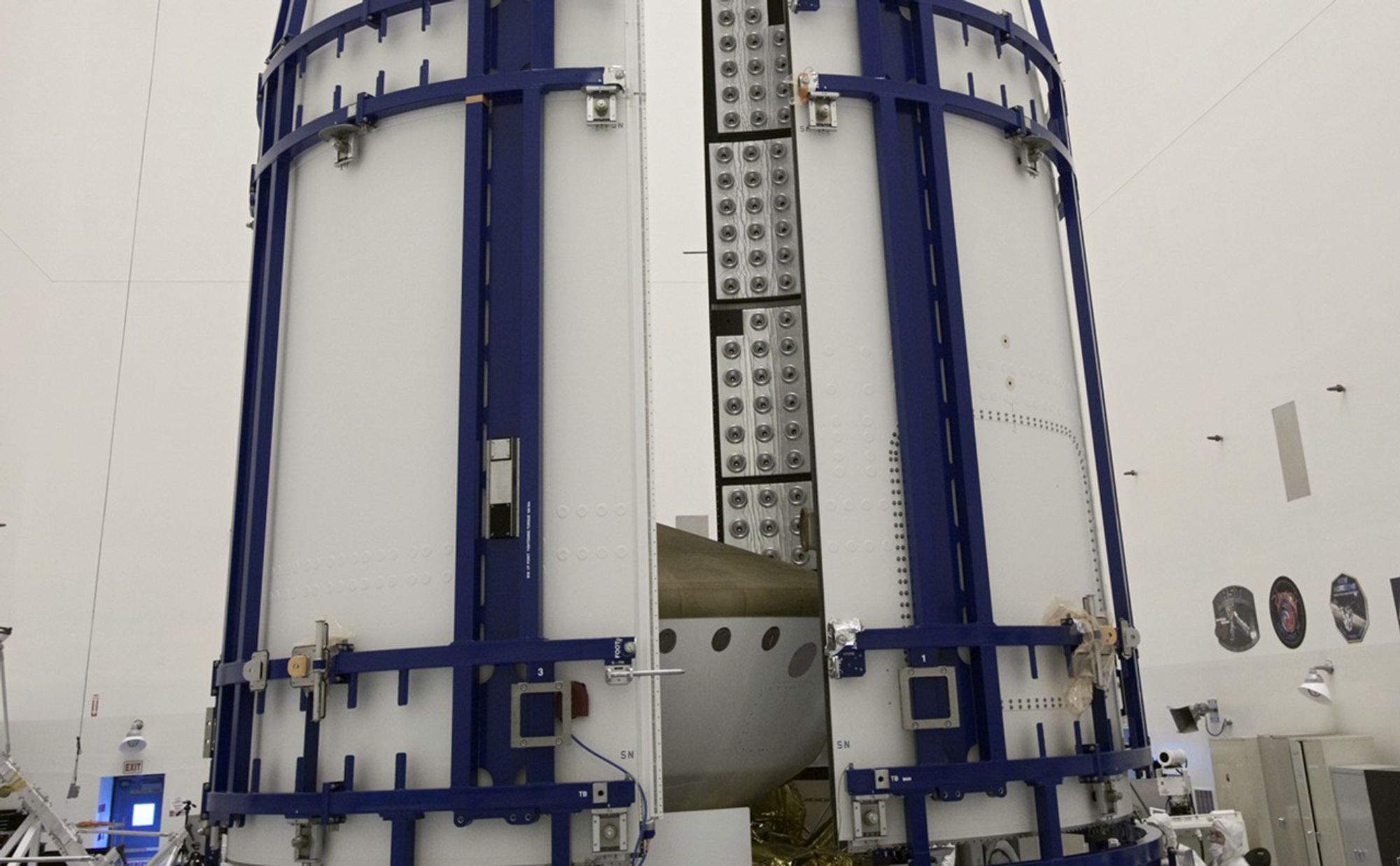 In the Payload Hazardous Servicing Facility at NASA's Kennedy Space Center in Florida, sections of an Atlas V rocket payload fairing obscure NASA's Mars Science Laboratory (MSL) from view as they close in around it.