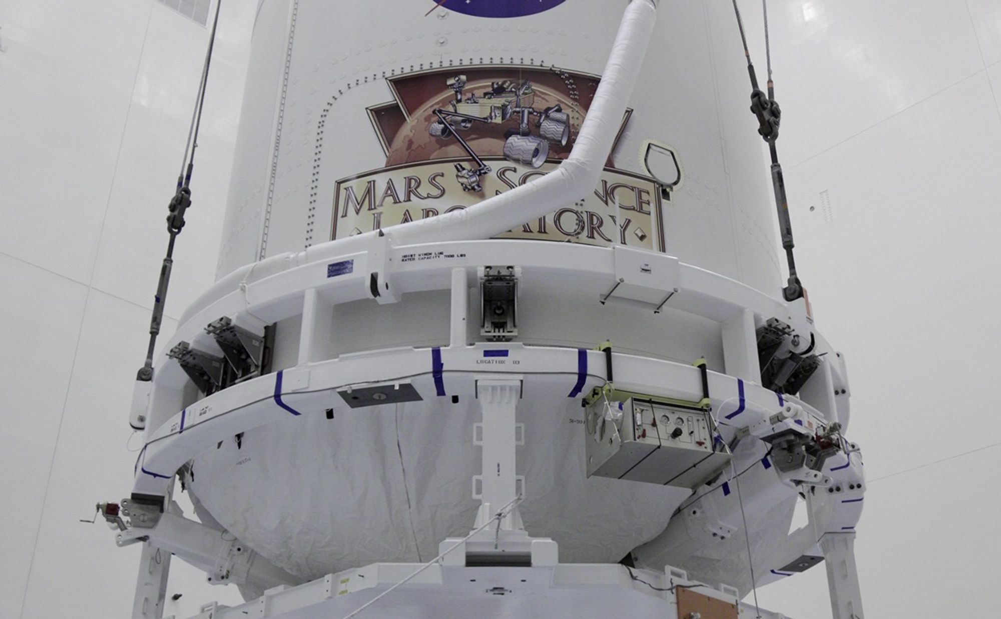 The Atlas V payload fairing containing NASA's Mars Science Laboratory (MSL) spacecraft rises above the floor of the Payload Hazardous Servicing Facility at Kennedy Space Center in Florida.