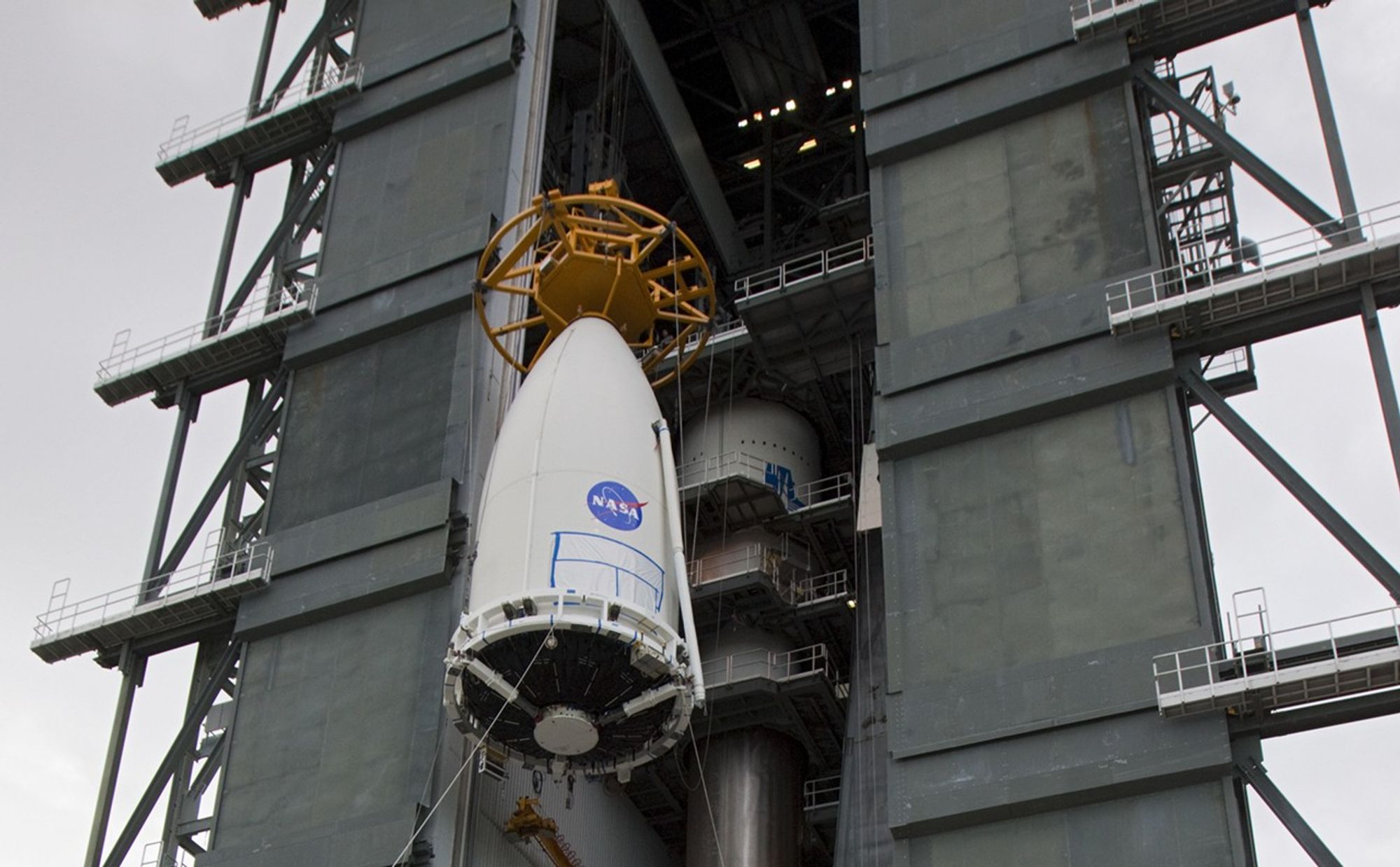 Employees at Space Launch Complex 41 of Cape Canaveral Air Force Station, Fla., keep watch as the payload fairing containing NASA's Mars Science Laboratory spacecraft is lifted up the side of the Vertical Integration Facility on Nov. 3, 2011.