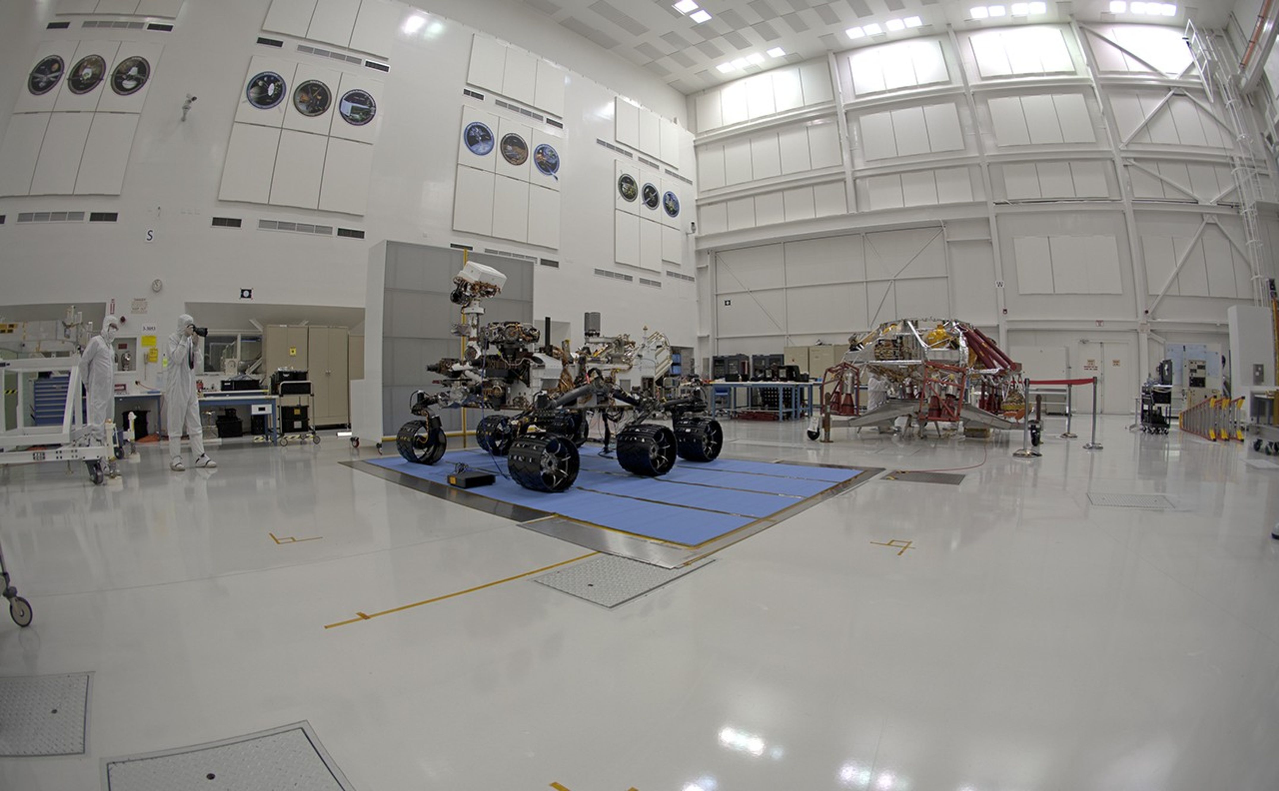 NASA's Curiosity rover and its powered descent vehicle pose for photographs prior to being integrated for launch at JPL's Spacecraft Assembly Facility.