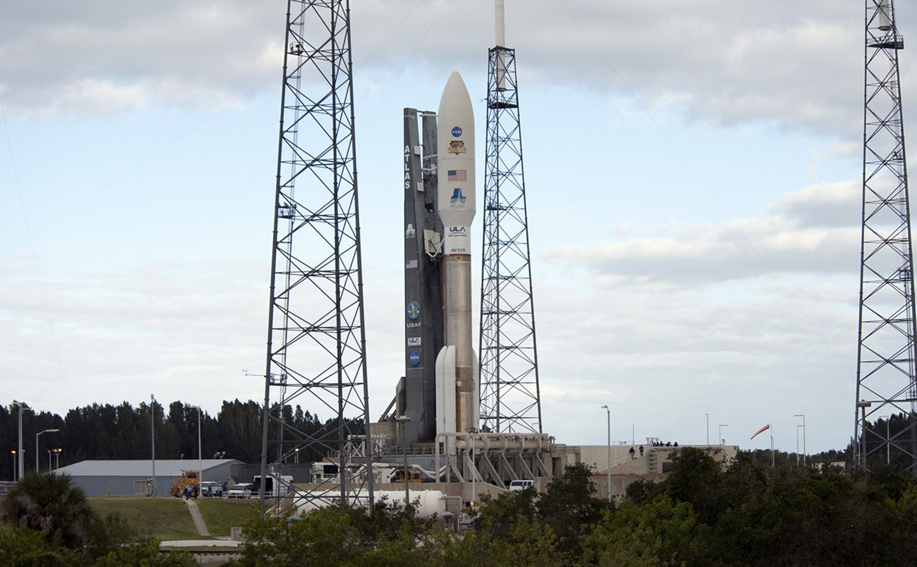 On Cape Canaveral Air Force Station in Florida, lightning masts protect the 197-foot-tall United Launch Alliance Atlas V rocket as it leaves behind the safety of the Vertical Integration Facility (VIF) at Space Launch Complex-41 to take its position on the pad's surface.