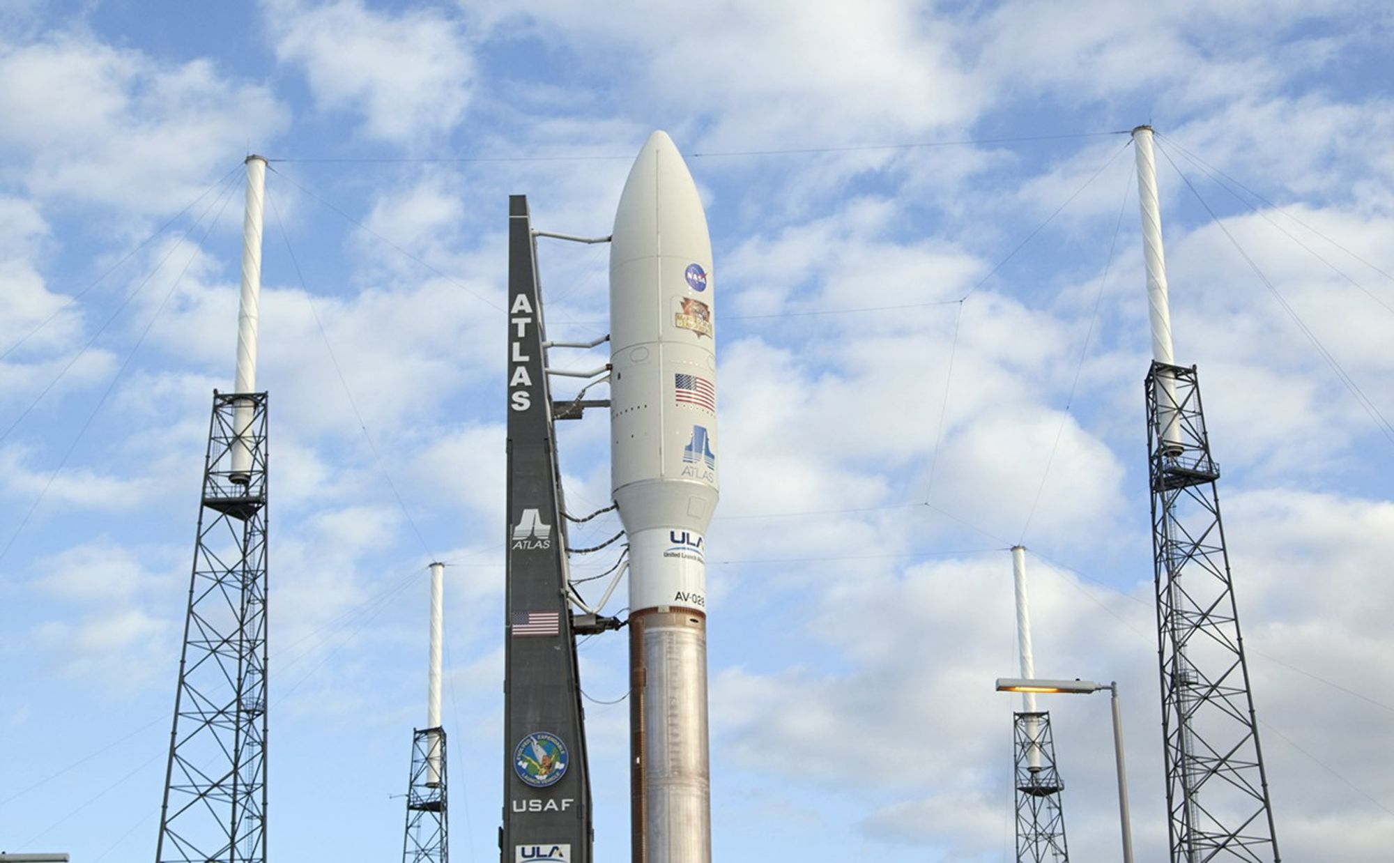 The 197-foot-tall United Launch Alliance Atlas V rocket seems surrounded by lightning masts as it arrives at the launch pad at Space Launch Complex 41 on Cape Canaveral Air Force Station in Florida. Atop the rocket is NASA's Mars Science Laboratory (MSL), enclosed in its payload fairing.