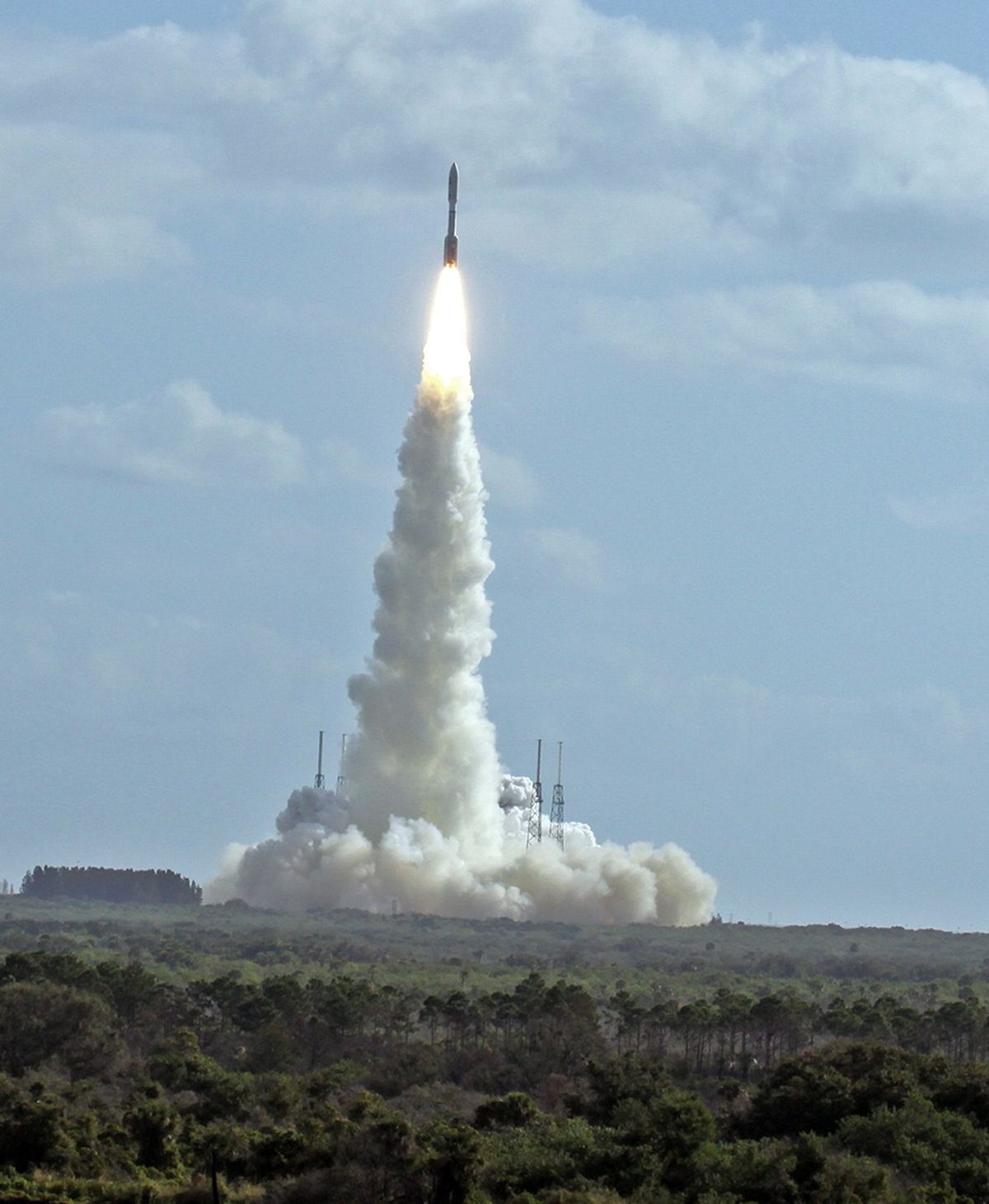 With NASA's Mars Science Laboratory (MSL) spacecraft sealed inside its payload fairing, the United Launch Alliance Atlas V rocket rides a pillar of smoke and flames as it lifts off from Space Launch Complex-41 on Cape Canaveral Air Force Station in Florida at 10:02 a.m. EST Nov. 26.