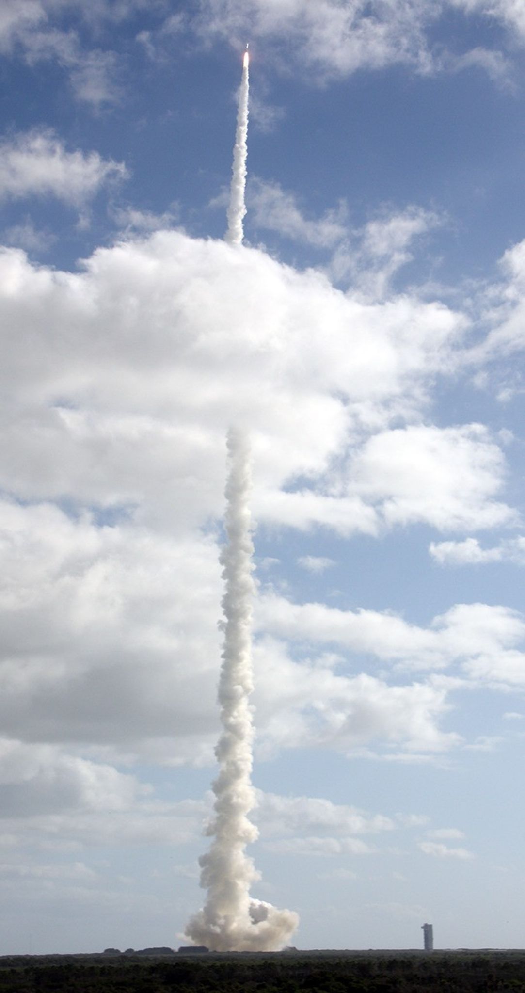 With NASA's Mars Science Laboratory (MSL) spacecraft sealed inside its payload fairing, the United Launch Alliance Atlas V rocket rides a tall pillar of smoke and flames as it soars over Space Launch Complex-41 on Cape Canaveral Air Force Station in Florida, after liftoff at 10:02 a.m. EST Nov. 26.