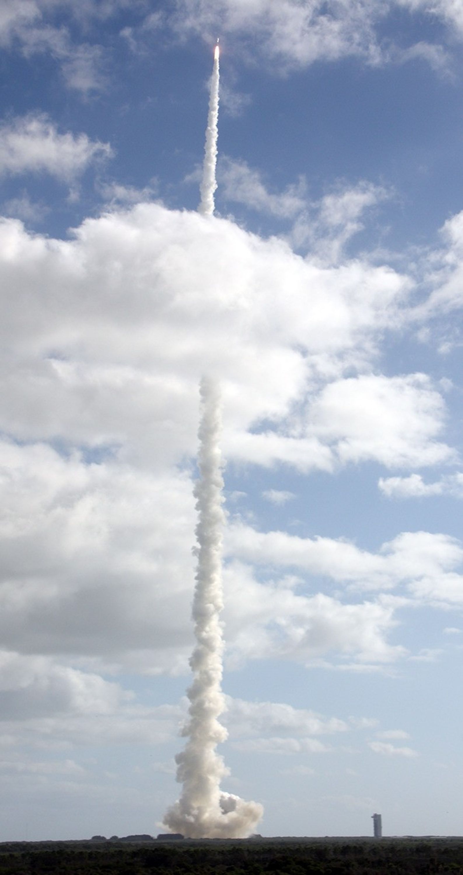 With NASA's Mars Science Laboratory (MSL) spacecraft sealed inside its payload fairing, the United Launch Alliance Atlas V rocket rides a tall pillar of smoke and flames as it soars over Space Launch Complex-41 on Cape Canaveral Air Force Station in Florida, after liftoff at 10:02 a.m. EST Nov. 26.