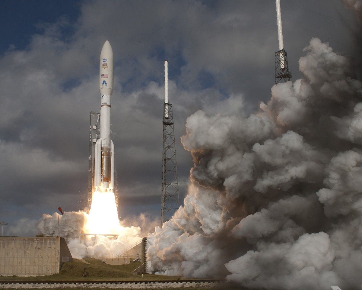 With NASA's Mars Science Laboratory (MSL) spacecraft sealed inside its payload fairing, the United Launch Alliance Atlas V rocket rides smoke and flames as it rises from the launch pad at Space Launch Complex-41 on Cape Canaveral Air Force Station in Florida at 10:02 a.m. EST Nov. 26.