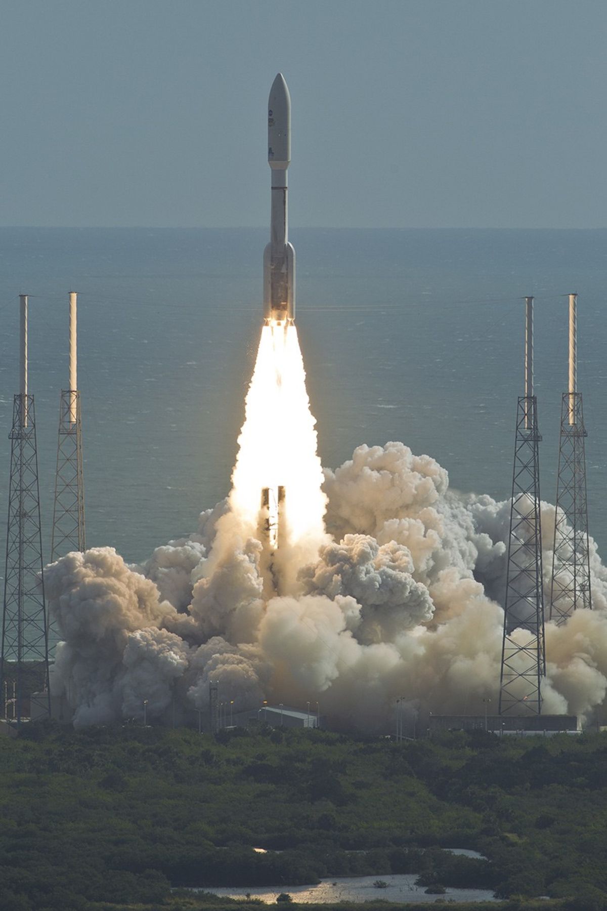 With NASA's Mars Science Laboratory (MSL) spacecraft sealed inside its payload fairing, the United Launch Alliance Atlas V rocket rides smoke and flames as it rises from the launch pad at Space Launch Complex-41 on Cape Canaveral Air Force Station in Florida at 10:02 a.m. EST Nov. 26.