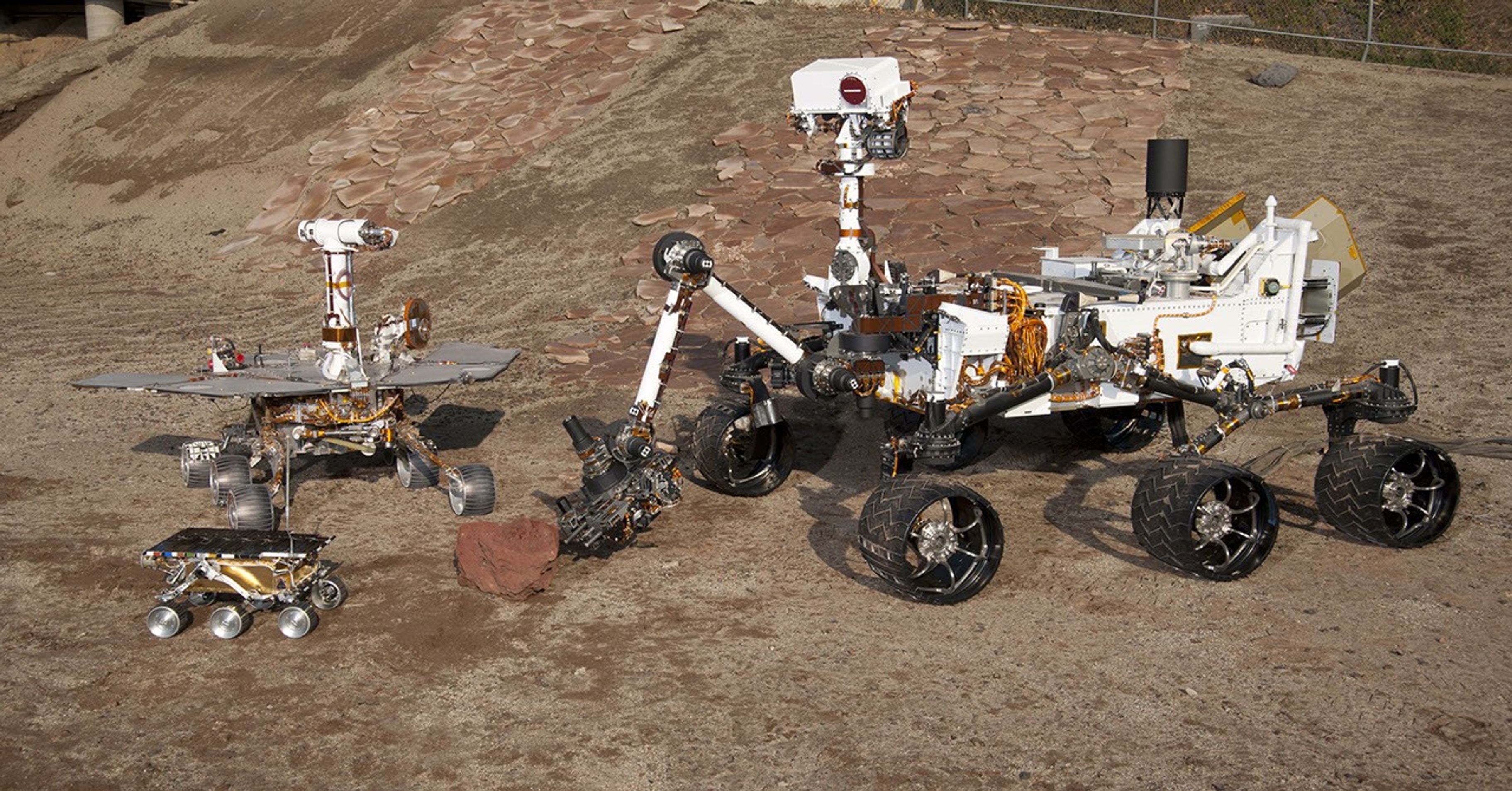 This grouping of two test rovers and a flight spare provides a graphic comparison of three generations of Mars rovers developed at NASA's Jet Propulsion Laboratory, Pasadena, Calif. The setting is JPL's Mars Yard testing area.