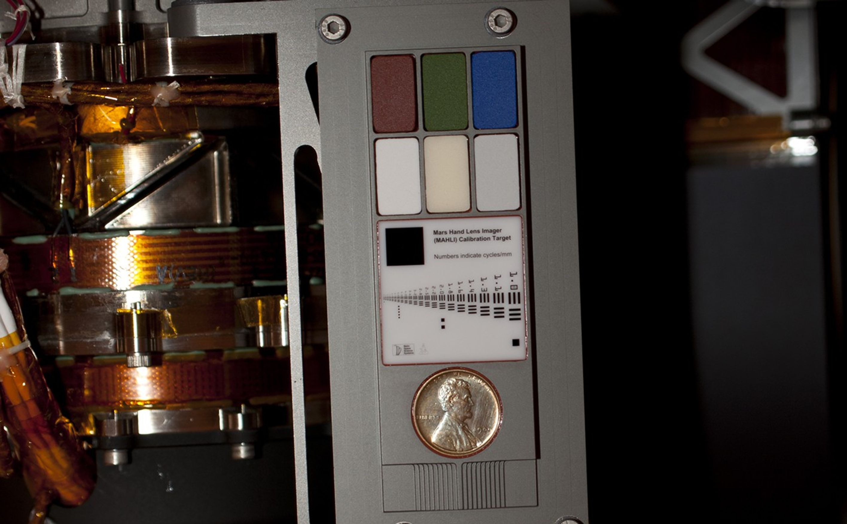 Two instruments at the end of the robotic arm on NASA's Mars rover Curiosity will use calibration targets attached to a shoulder joint of the arm.