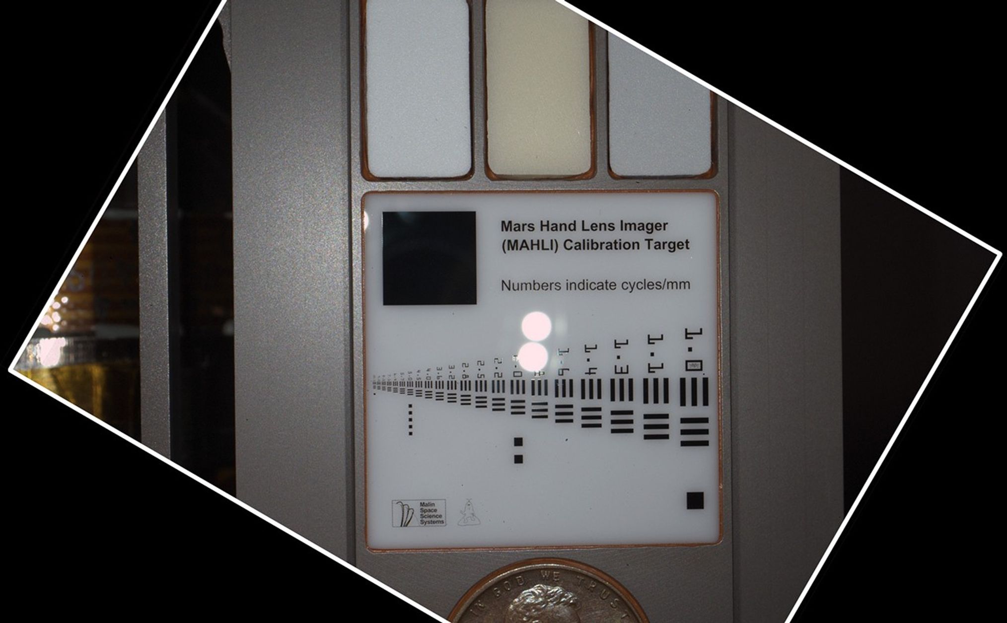 During pre-flight testing, the Mars Hand Lens Imager (MAHLI) camera on NASA's Mars rover Curiosity took this image of the MAHLI calibration target from a distance of 3.94 inches (10 centimeters) away from the target.