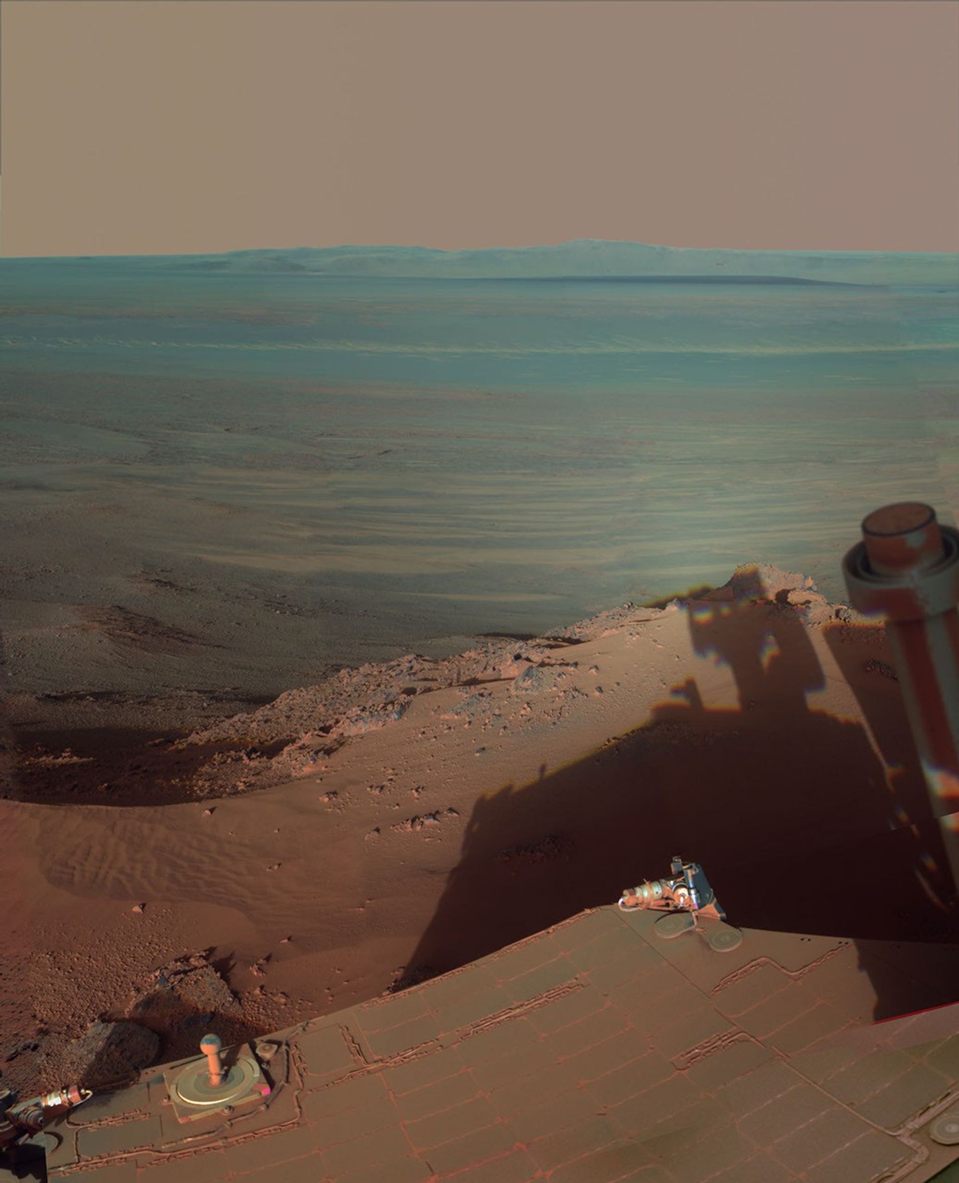 NASA's Mars Rover Opportunity catches its own late-afternoon shadow in this dramatically lit view eastward across Endeavour Crater on Mars.