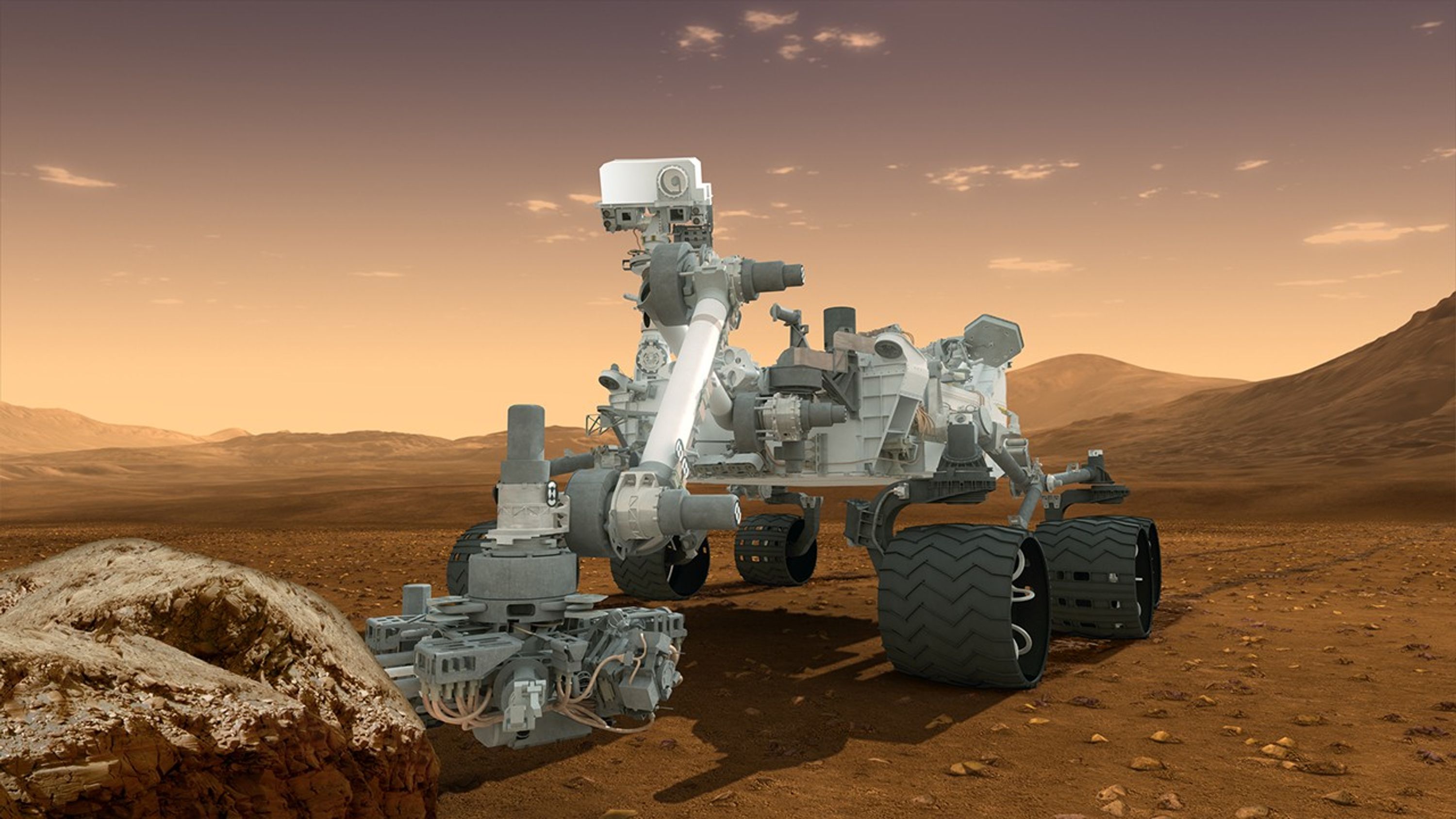 In this picture, the rover examines a rock on Mars with a set of tools at the end of the rover's arm, which extends about 7 feet (2 meters).