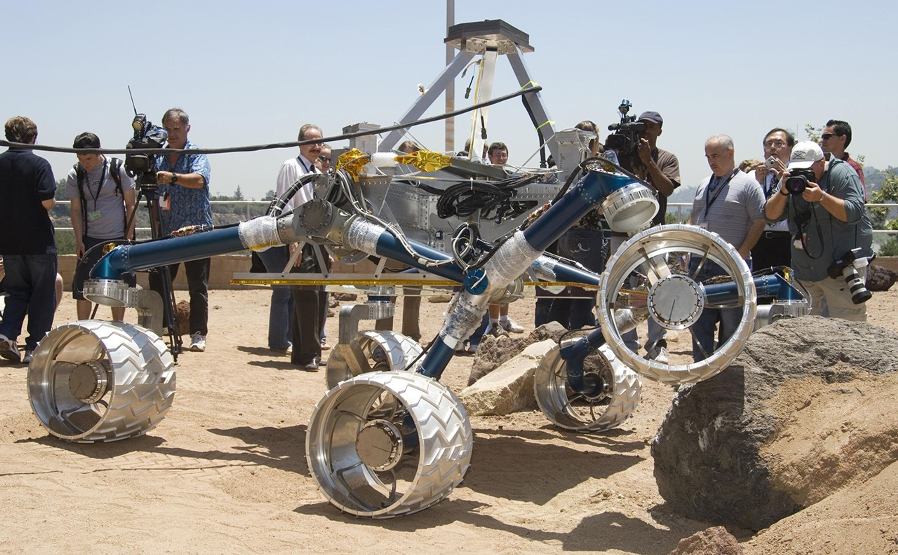 Onlookers watch as Scarecrow, a mobility-testing model for NASA's Mars Science Laboratory, easily conquers boulders in the Mars Yard testing area at NASA's Jet Propulsion Laboratory.