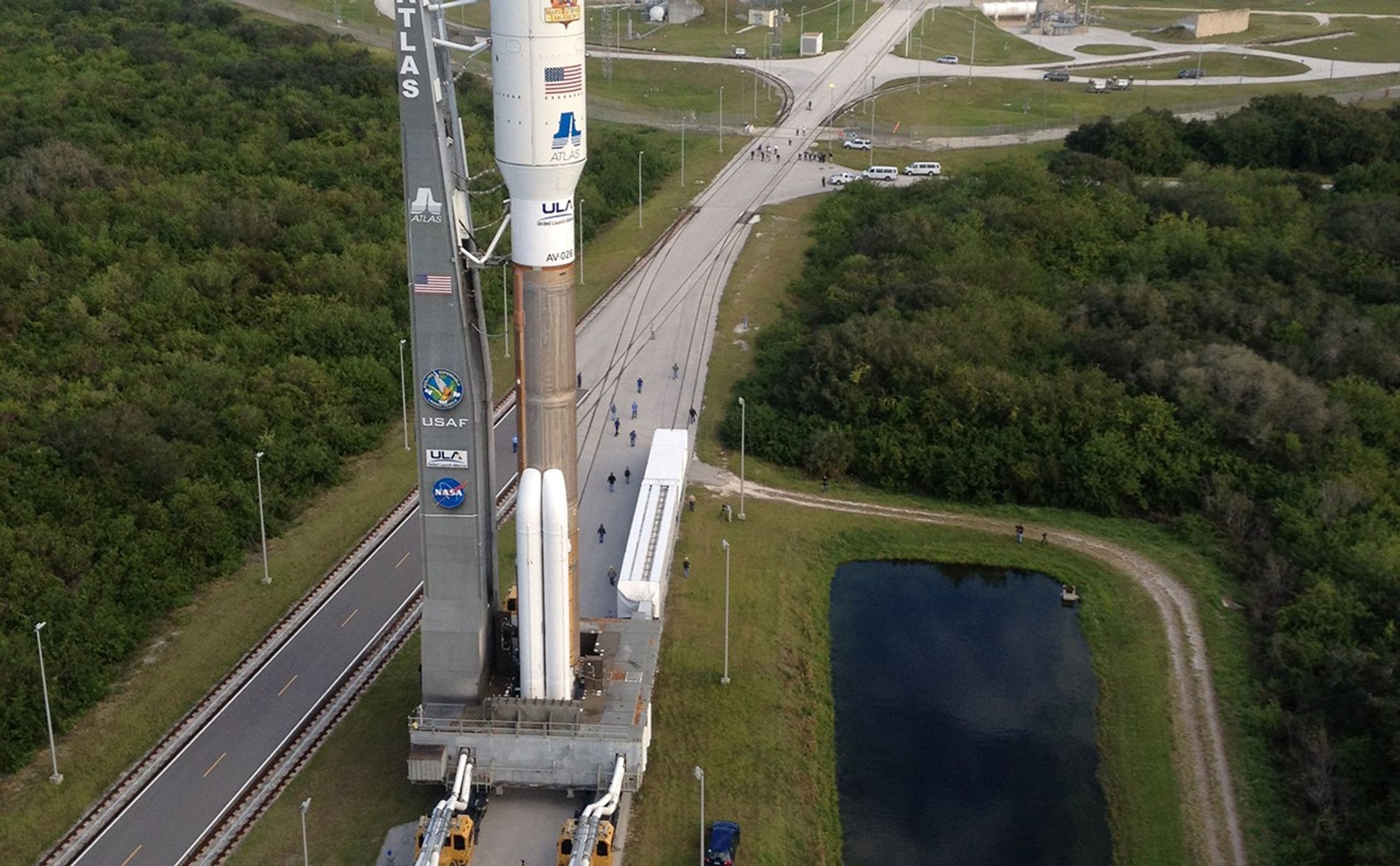 Backdropped by the Atlantic Ocean, the 197-foot-tall United Launch Alliance Atlas V rocket rolls toward the launch pad at Space Launch Complex 41 on Cape Canaveral Air Force Station in Florida. Atop the rocket is NASA's Mars Science Laboratory (MSL), enclosed in its payload fairing.