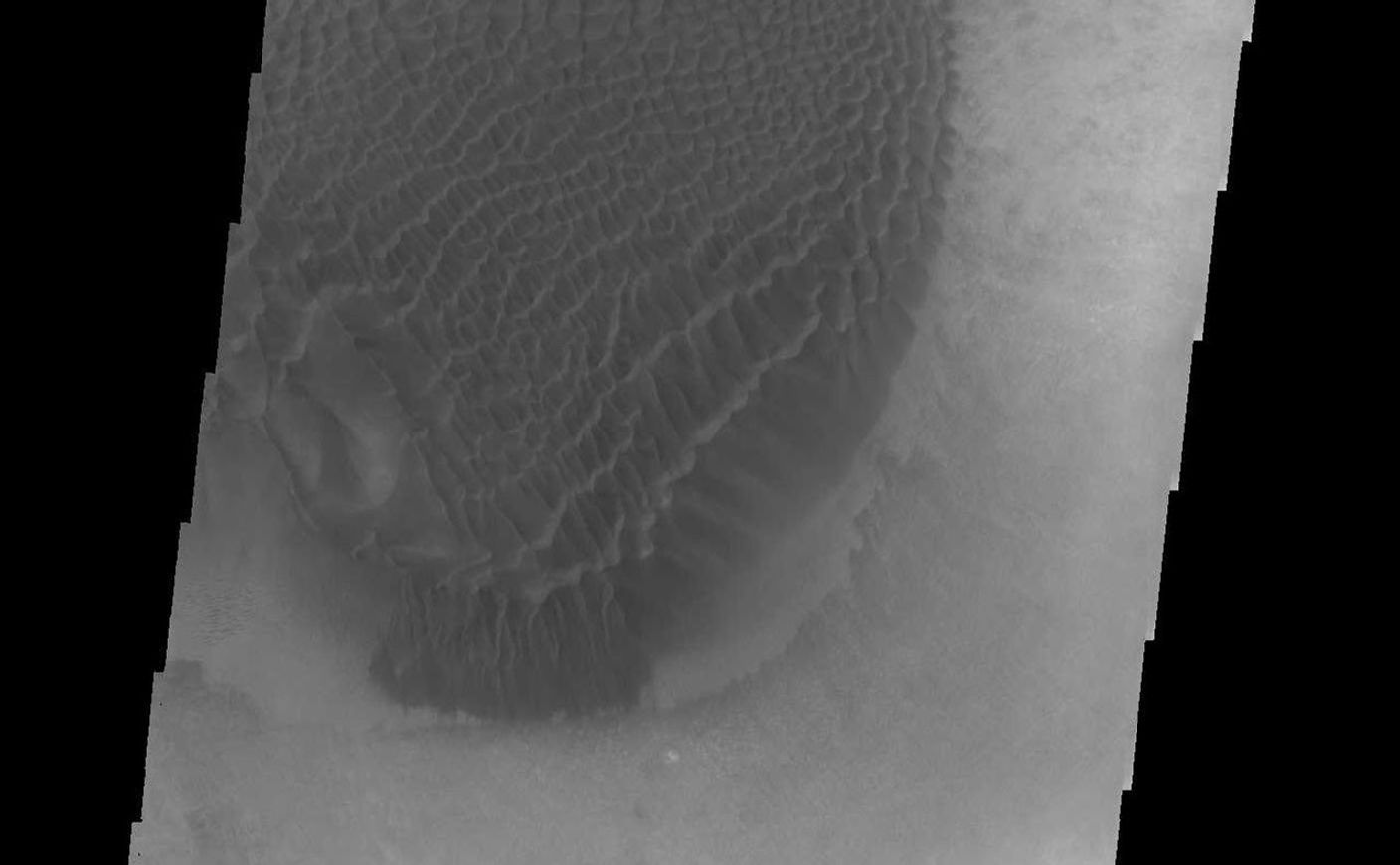 A large mound of sand and dune forms are located on the floor of an unnamed crater south of Rabe Crater in Noachis Terra.