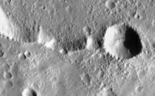 Elysium Mons is one of three large volcanoes that occur on the Elysium Rise-- the others are Hecates Tholus (northeast of Elysium Mons) and Albor Tholus (southeast of Elysium Mons). The volcano rises about 12.5 kilometers (7.8 miles) above the surrounding plain, or about 16 kilometers (9.9 miles) above the martian datum-- the "zero" elevation defined by average martian atmospheric pressure and the planet's radius.