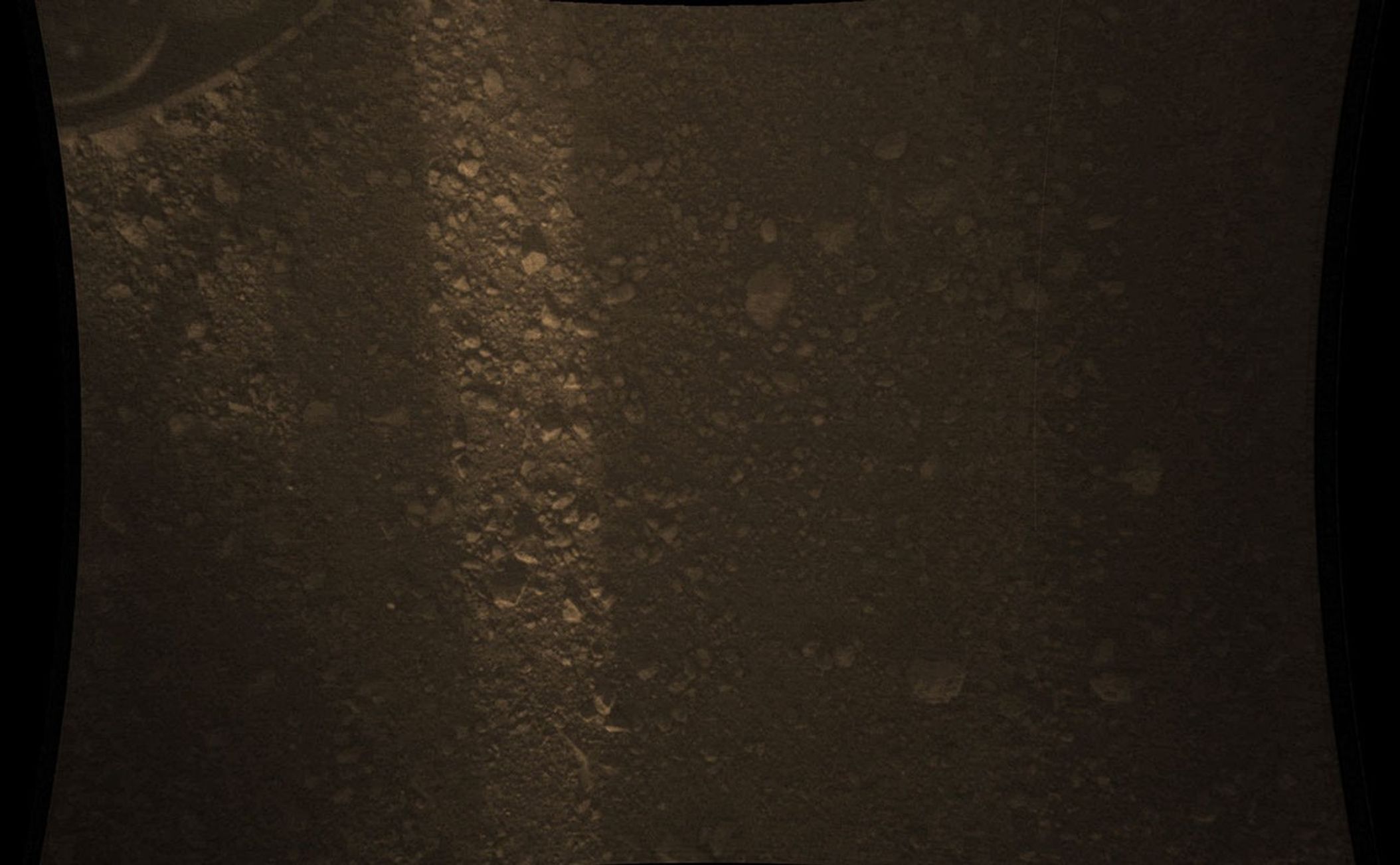 This full-resolution color image from NASA's Curiosity Rover shows the gravel-covered surface of Mars. It was taken by the Mars Descent Imager (MARDI) several minutes after Curiosity touched down on Mars.