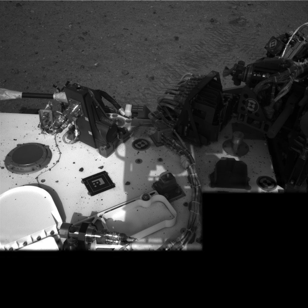 This image taken by NASA's Curiosity rover shows track marks from a successful drive to the scour mark known as Goulburn, an area of bedrock exposed by thrusters on the rover's descent stage. The scour mark cannot be seen in this view.