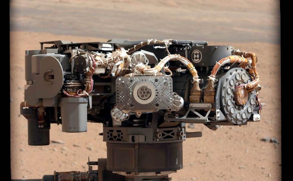 This image shows the Alpha Particle X-Ray Spectrometer (APXS) on NASA's Curiosity rover, with the Martian landscape in the background.