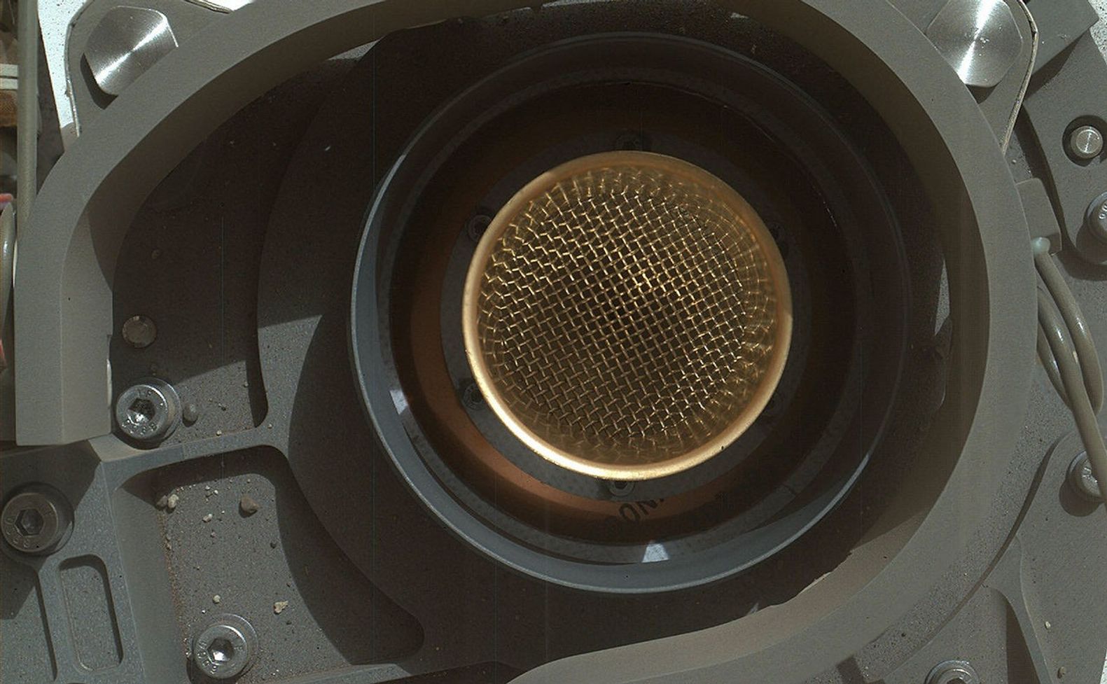 This image from NASA's Curiosity rover shows the open inlet where powdered rock and soil samples will be funneled down for analysis.