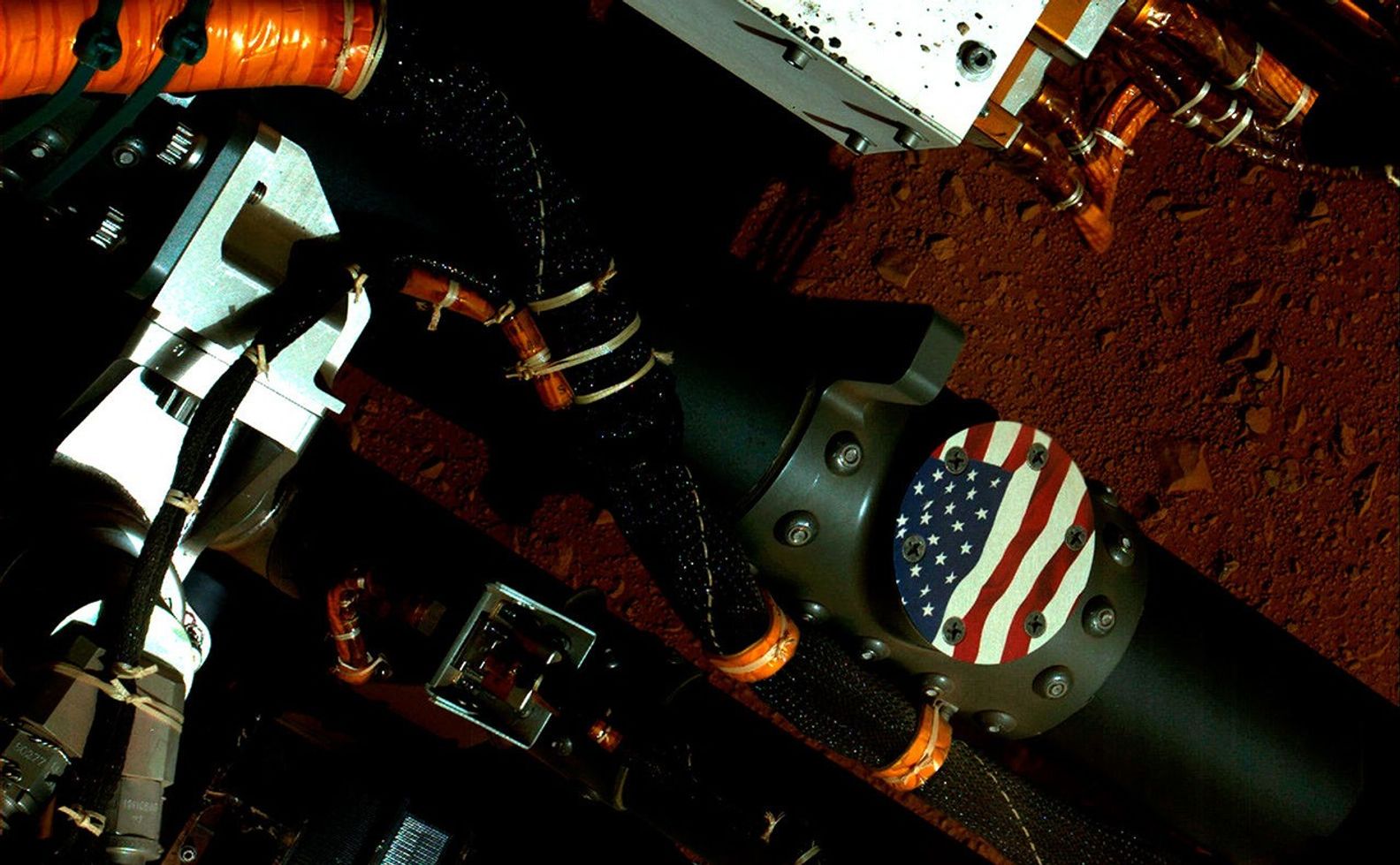 This view of the American flag medallion on NASA's Mars rover Curiosity was taken by the rover's Mars Hand Lens Imager (MAHLI) during the 44th Martian day, or sol, of Curiosity's work on Mars (Sept. 19, 2012).