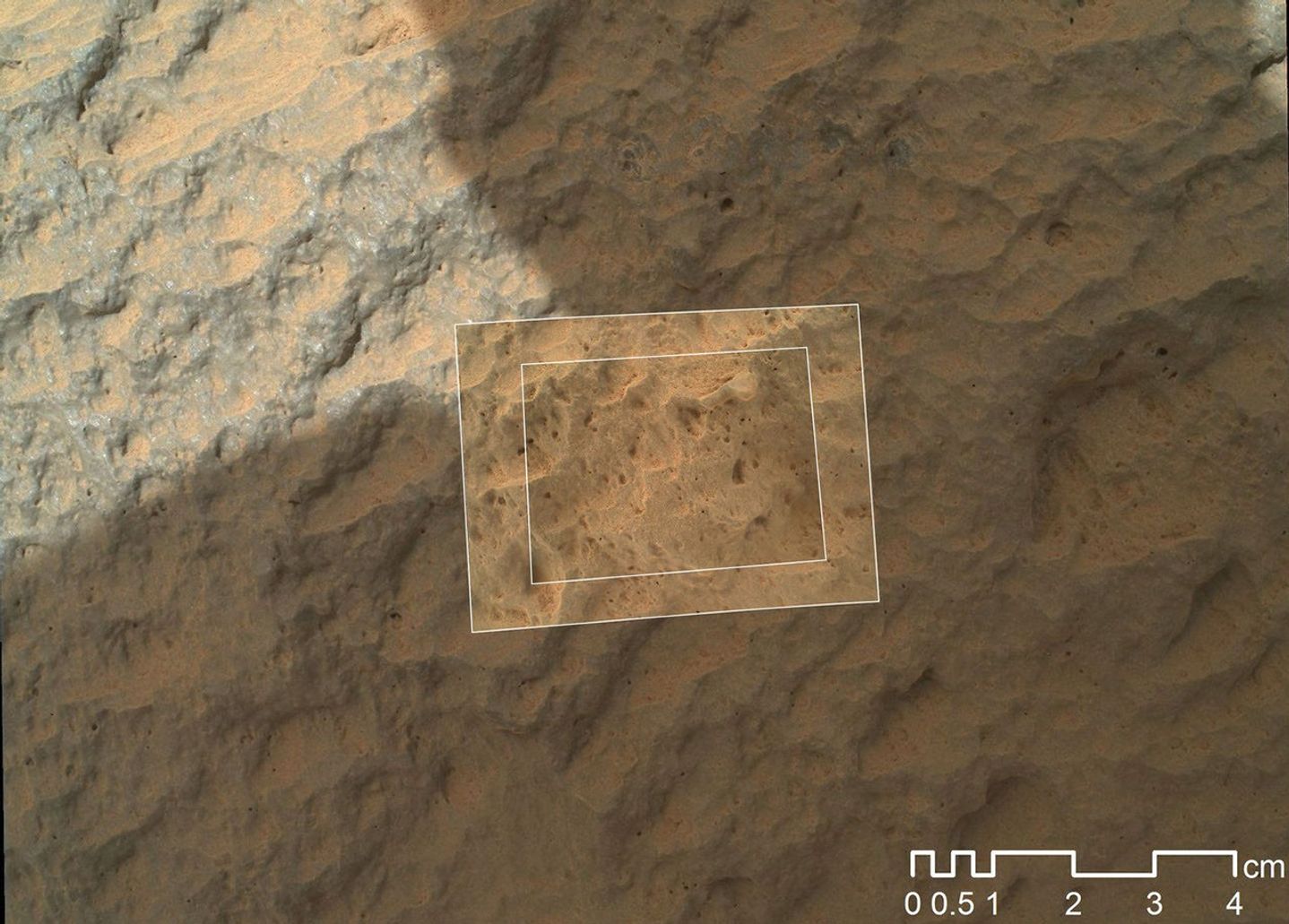 This image combines photographs taken by the Mars Hand Lens Imager (MAHLI) at three different distances from the first Martian rock that NASA's Curiosity rover touched with its arm.