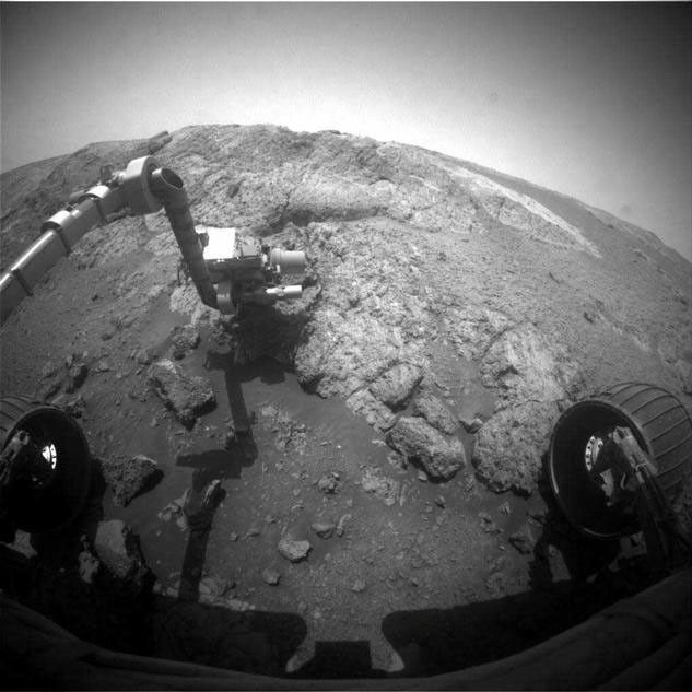 This image from the front hazard-avoidance camera (Hazcam) on the NASA Mars Exploration Rover Opportunity shows the rover's arm extended for examination of a target called "Onaping" at the base of an outcrop called "Copper Cliff" in the Matijevic Hill area of the west rim of Endeavour Crater.