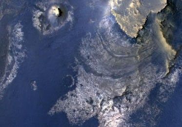 This view of layered rocks on the floor of McLaughlin Crater shows sedimentary rocks that contain spectroscopic evidence for minerals formed through interaction with water.