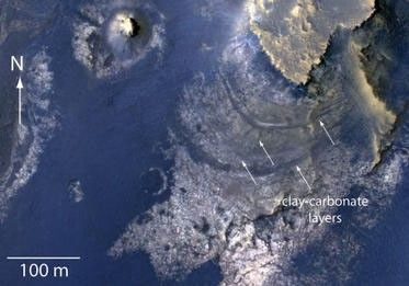 This view of layered rocks on the floor of McLaughlin Crater shows sedimentary rocks that contain spectroscopic evidence for minerals formed through interaction with water.