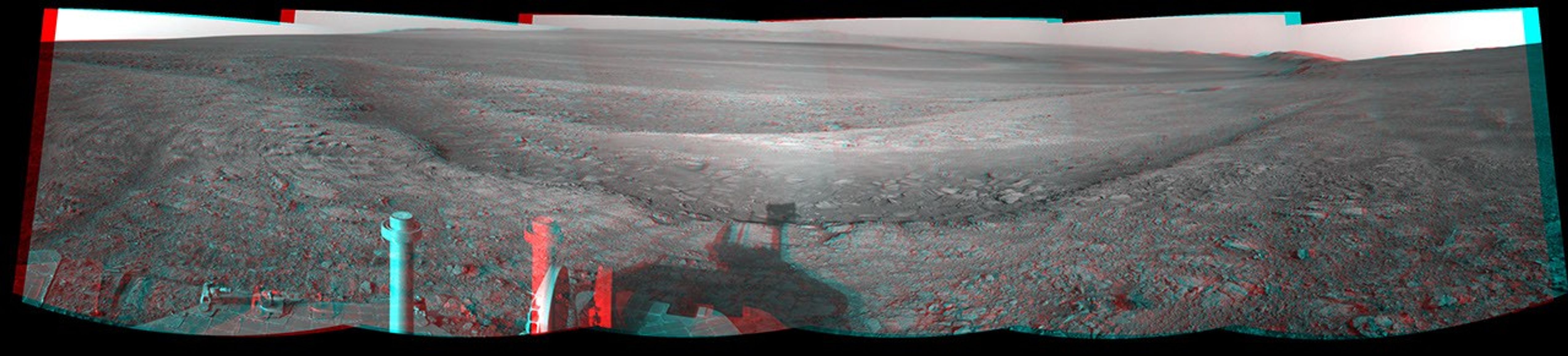This stereo view from the navigation camera on NASA's Mars Exploration Rover Opportunity shows a vista across Endeavour Crater, with the rover's own shadow in the foreground.