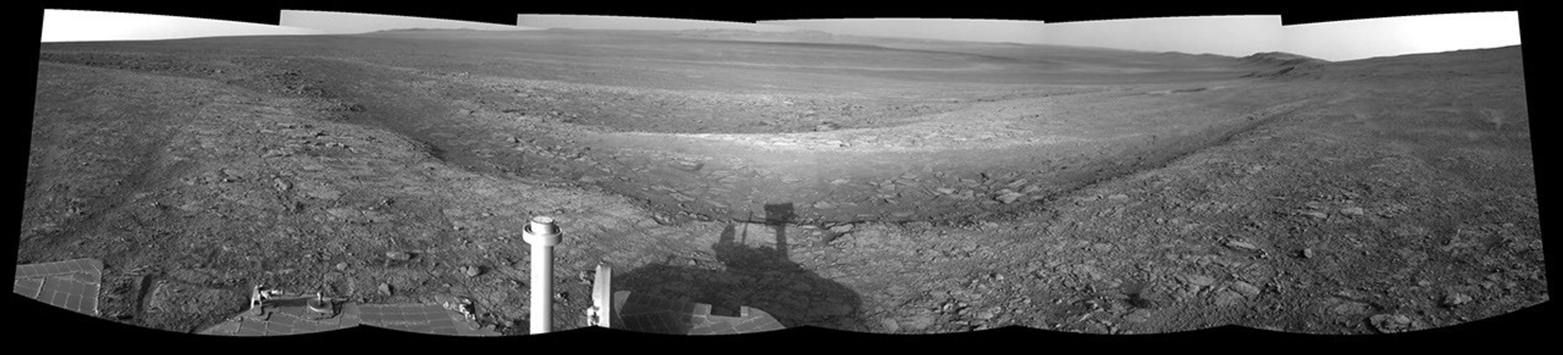 This left-eye member of a stereo pair of images from the navigation camera on NASA's Mars Exploration Rover Opportunity shows a vista across Endeavour Crater, with the rover's own shadow in the foreground.