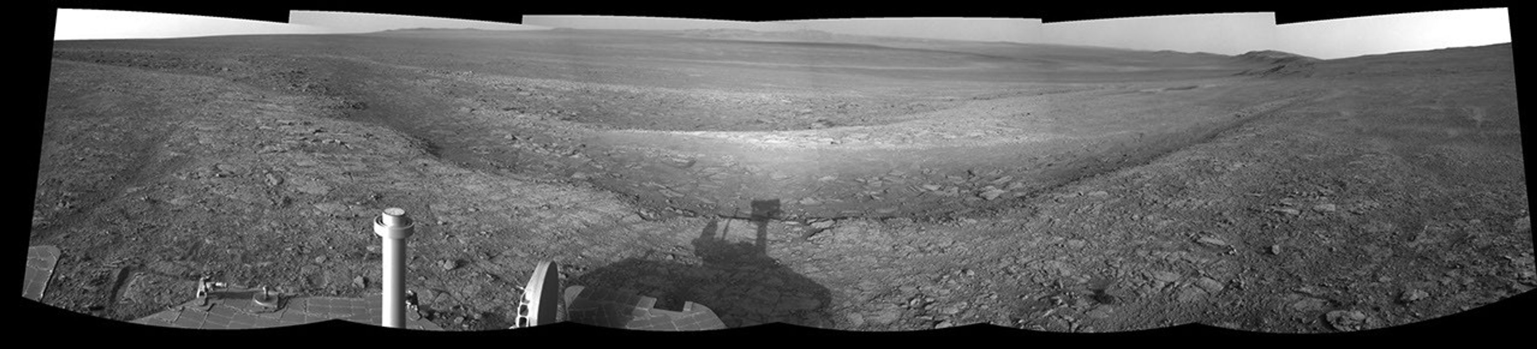 This right-eye member of a stereo pair of images from the navigation camera on NASA's Mars Exploration Rover Opportunity shows a vista across Endeavour Crater, with the rover's own shadow in the foreground.