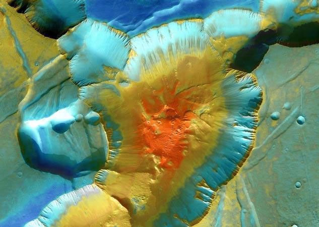 A false-color mosaic focuses on one junction in Noctis Labyrinthus where Mars canyons meet to form a depression 4,000 meters (13,000 feet) deep.