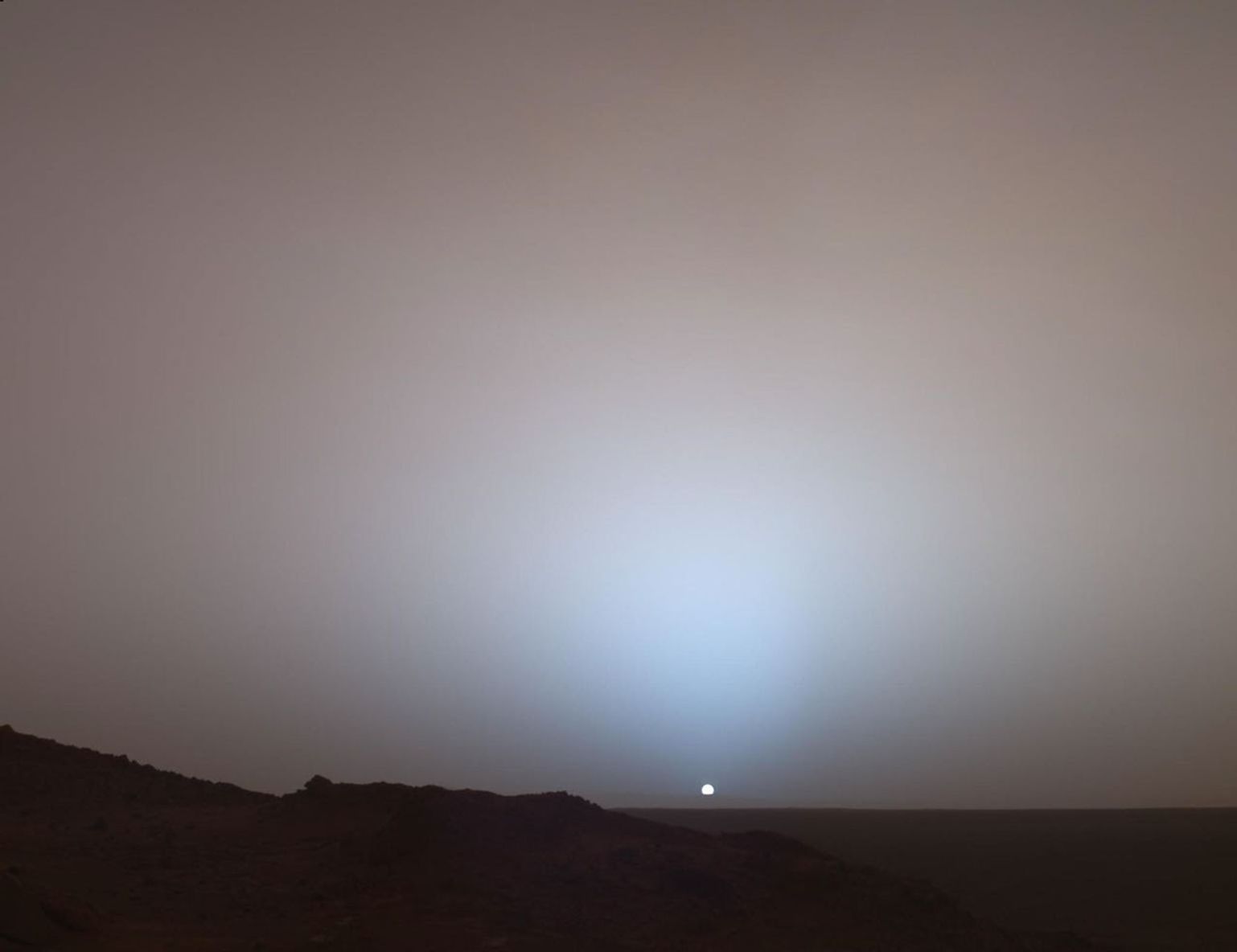 On May 19th, 2005, NASA's Mars Exploration Rover Spirit captured this stunning view as the Sun sank below the rim of Gusev crater on Mars.