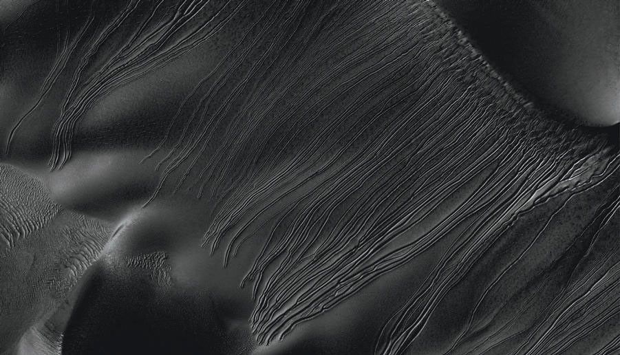 Several types of downhill flow features have been observed on Mars. This image from the High Resolution Imaging Science Experiment (HiRISE) camera on NASA's Mars Reconnaissance Orbiter is an example of a type called "linear gullies."