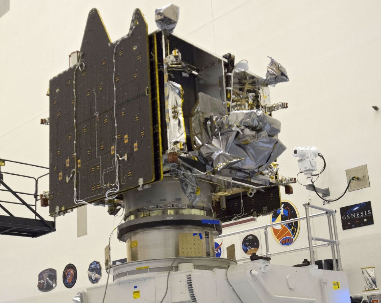 Technicians and engineers oversee MAVEN after it was attached to a processing stand.
