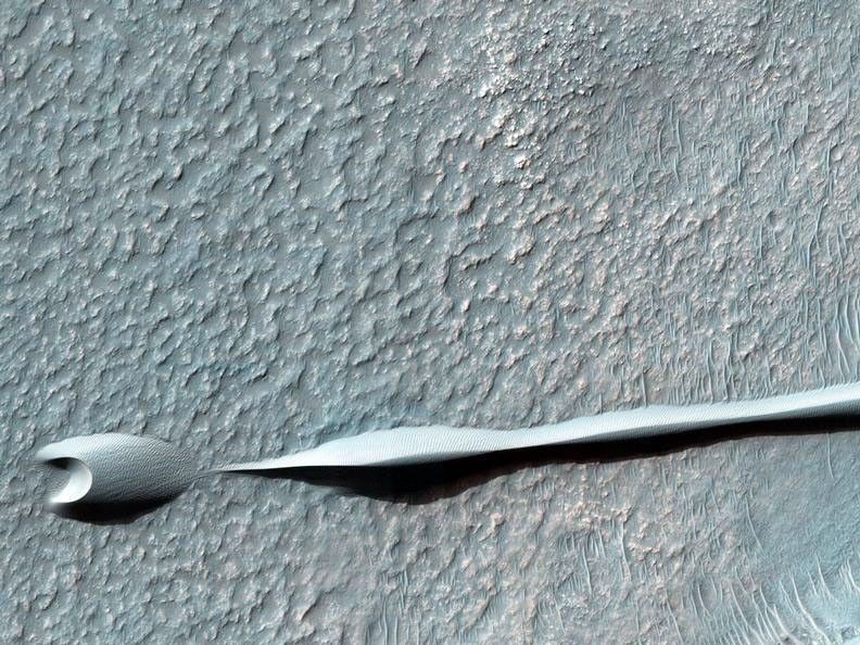 Sand dunes such as those seen in this image have been observed to creep slowly across the surface of Mars through the action of the wind.